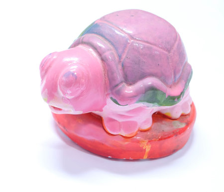 Painted ceramic turtle isolated on white backgroundの写真素材