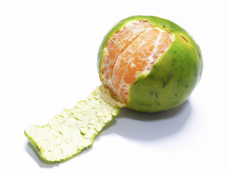 Peeled green orange isolated on white backgroundの写真素材