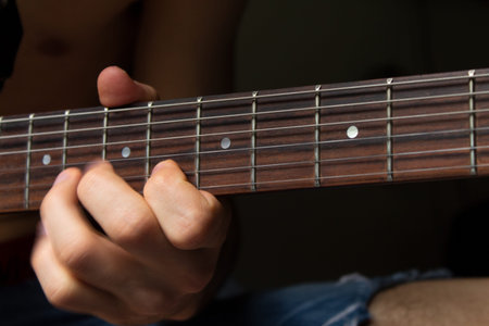 Man Playing The Guitar On The Sixth Fret. This image will fit perfectly for any of your projects:...