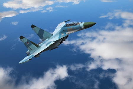 A modern fighter flies on the background of blue sky and clouds