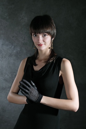 Portrait of the beautiful girl against a dark gray wallの写真素材