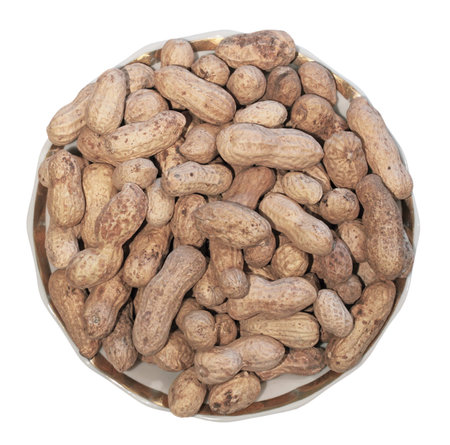 Peanut in a saucer, the top view, it is isolated on a white background