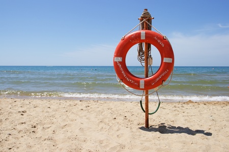 Life buoy on a beach against the seaの写真素材
