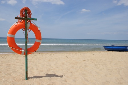 Life buoy on a beach against the seaの写真素材