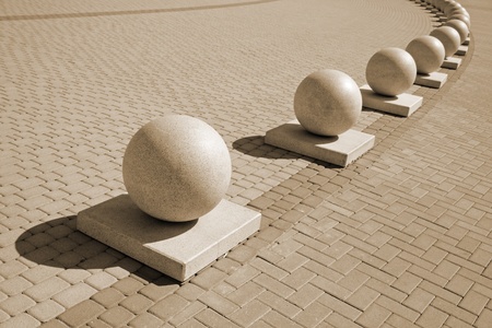 Protection in the form of decorative stone spheres on sidewalkの写真素材