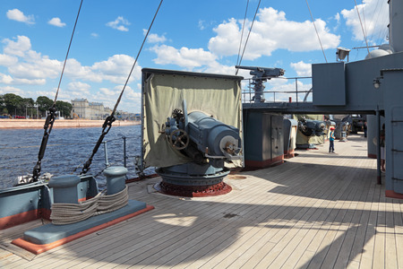 ST.-PETERSBURG - JUL 02: The famous revolutionary ship cruiser Aurora on the Neva river on Jul 02, 2013 in Saint-Petersburg, Russia. Artillery gun on the deck of the ship.のeditorial素材