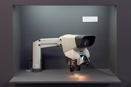 SAINT-PETERSBURG - JUN 05: Demonstration of the mechanism of MMG-EPTRON (Micromechanical gyro) using a microscope on 6th international maritime defense show (IMDS-2013) on Jun 05, 2013 in Lenexpo exhibition complex, Saint-Petersburg, Russia.のeditorial素材