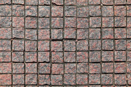 Motley granite pavement a rough square tiles