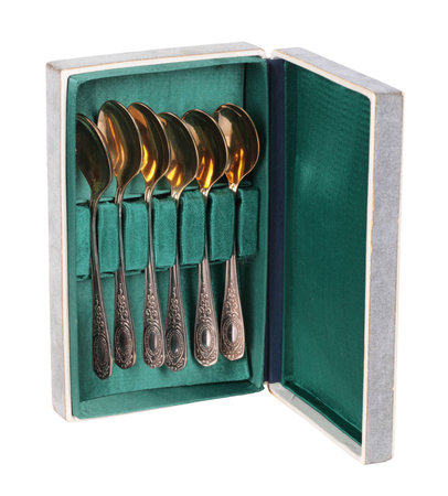 Old Melchior spoons in a box, isolated on white の写真素材