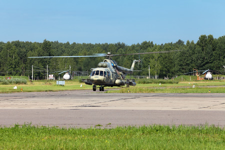 The military helicopter at the airfield preparing for take-off