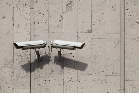 Two outdoor camera surveillance and control on the grey wall of the buildingの写真素材