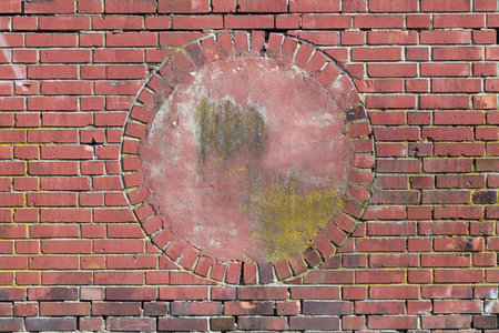 Wall of red bricks with a circular alcove in the middleの写真素材