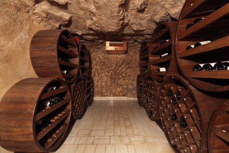 A small wine cellar with silence on the shelves of wine bottles, nobody