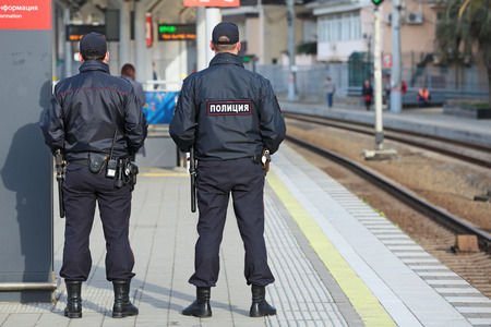 SOCHI, RUSSIA - MAR, 8, 2014: The two police officers patrols the railway station Hosta. Increased security measures because of the sports competition winter gamesのeditorial素材