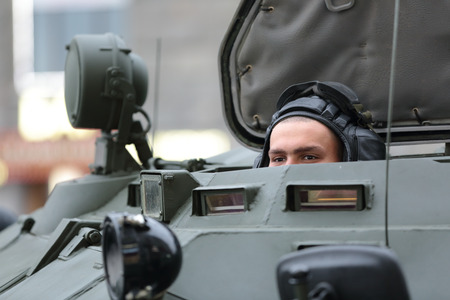 MOSCOW, RUSSIA - MAY 05, 2014: Rehearsal celebration of the 69th anniversary of the Victory Day (WWII). The soldier looks out from APCのeditorial素材