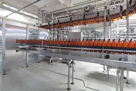 The food industry. Plastic beer bottles moving on conveyorのeditorial素材
