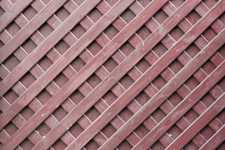The texture of the brown wooden surface with a grid of thin stripsの写真素材