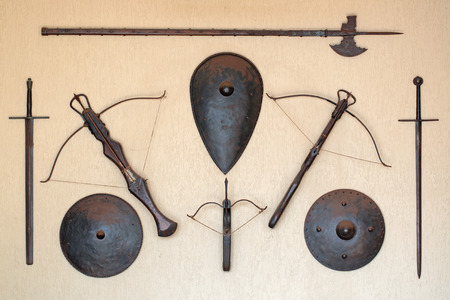 The old medieval weapons and shields on the wallの写真素材
