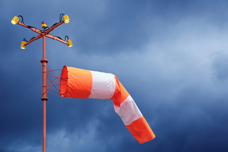 Airfield sign of the direction and force of the wind against cloudy blue skyの写真素材