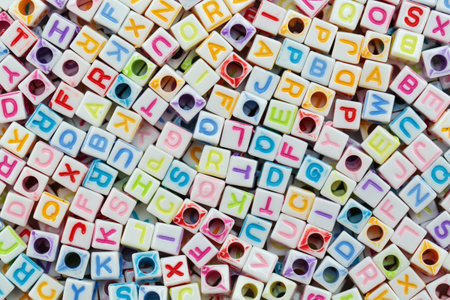 Multi-colored beads with characters of the Latin alphabet, background