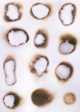 Sheet of paper with the scorched by fire a hole in itの写真素材