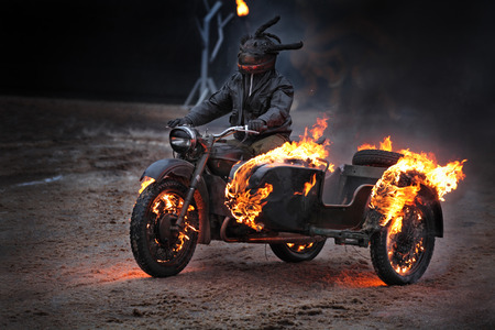 A man drives a motorcycle burningの写真素材