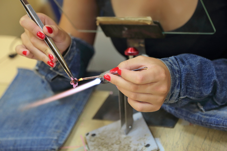 Lampworking - artistic treatment of glass in the flame. Woman master workの写真素材