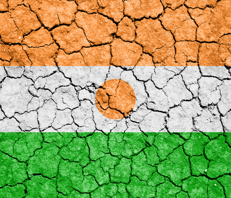 The image of the flag of Republic of Niger on the cracked dry groundの写真素材
