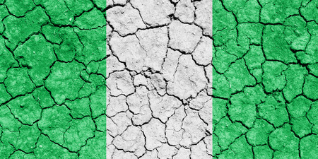 The image of the flag of Federal Republic of Nigeria on the cracked dry groundの写真素材