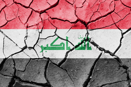 The image of the flag of Iraq on the cracked dry groundの写真素材