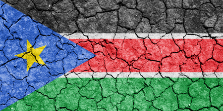 The image of the flag of Republic of South Sudan on the cracked dry groundの写真素材
