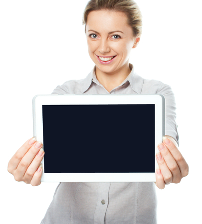 A young and happy girl holding a tablet computer isolated on a white backgroundの写真素材