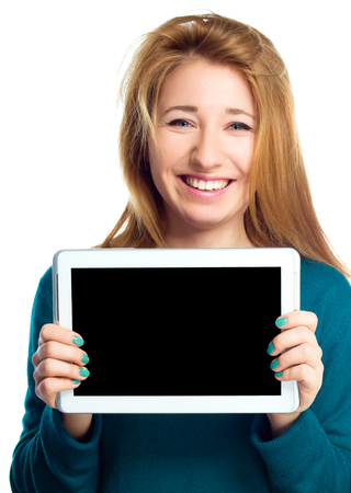 Young cheerful woman is showing blank tablet, isolated over whiteの写真素材