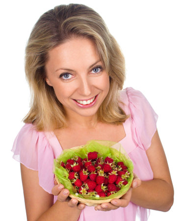 Close up of smiling woman holding raspberries isolated on whiteの写真素材
