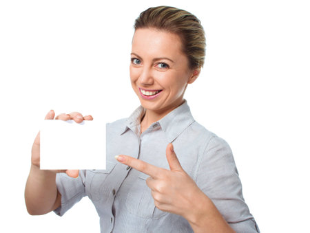 Attractive young woman showing empty blank paper card sign with copy space for text, isolated over whiteの写真素材