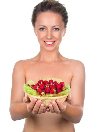 Close up of smiling woman holding raspberries isolated on whiteの写真素材