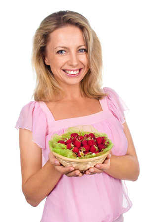 Close up of smiling woman holding raspberries isolated on whiteの写真素材