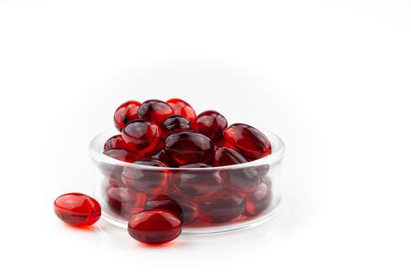 Red gel medical capsules, isolated on white background.の写真素材