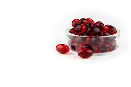 Red gel medical capsules, isolated on white background.の写真素材