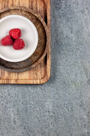 Rustic wooden plates, showing a mix of fresh berriesの写真素材