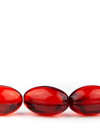 Red gel medical capsules, isolated on white background.の写真素材