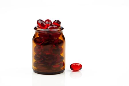 Red gel medical capsules, isolated on white background.の写真素材
