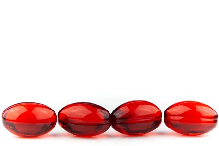 Red gel medical capsules, isolated on white background.の写真素材