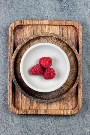 Rustic wooden plates, showing a mix of fresh berriesの写真素材