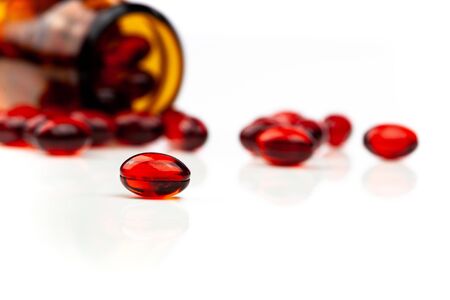 Red gel medical capsules, isolated on white background.の写真素材
