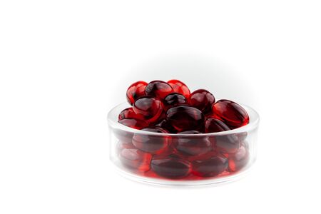 Red gel medical capsules, isolated on white background.の写真素材