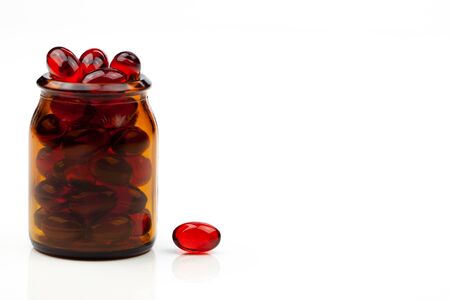 Red gel medical capsules, isolated on white background.の写真素材
