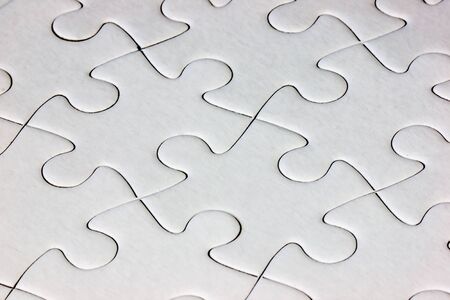 Close-up white jigsaw puzzle with all pieces connected - full frameの写真素材