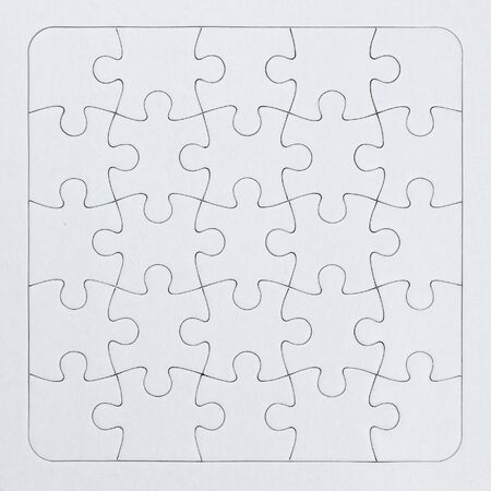 Close-up white jigsaw puzzle with all pieces connected - full frameの写真素材
