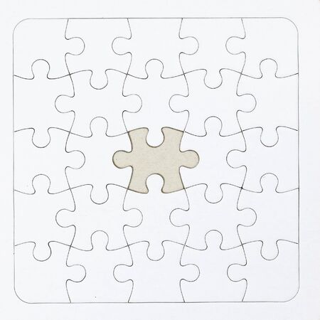Close-up white jigsaw puzzle with a missing piece - full frame white backgroundの写真素材